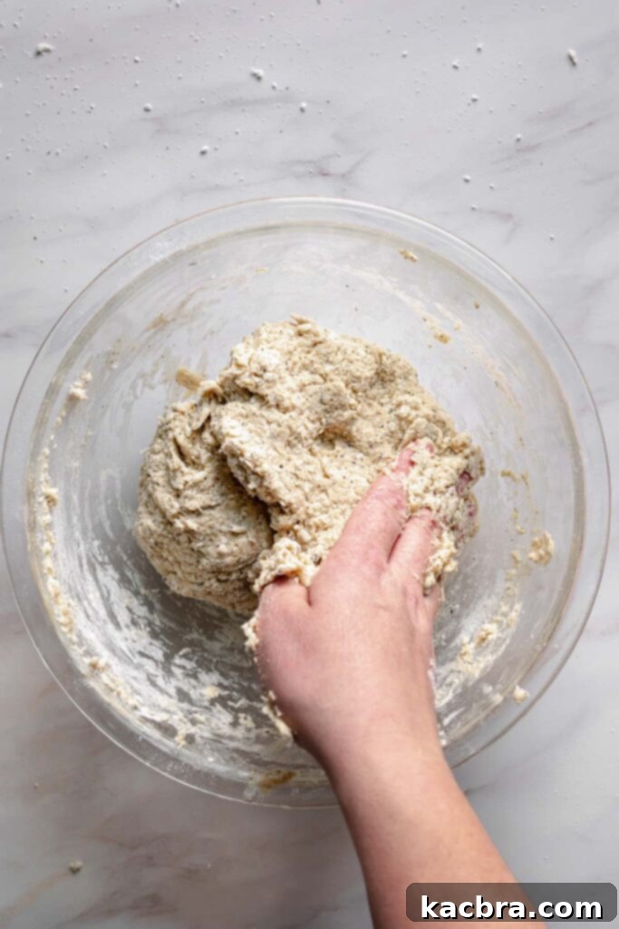 Bergamot Scones with Tangy Lemon Glaze 7 A hand forms the scone dough in a bowl.