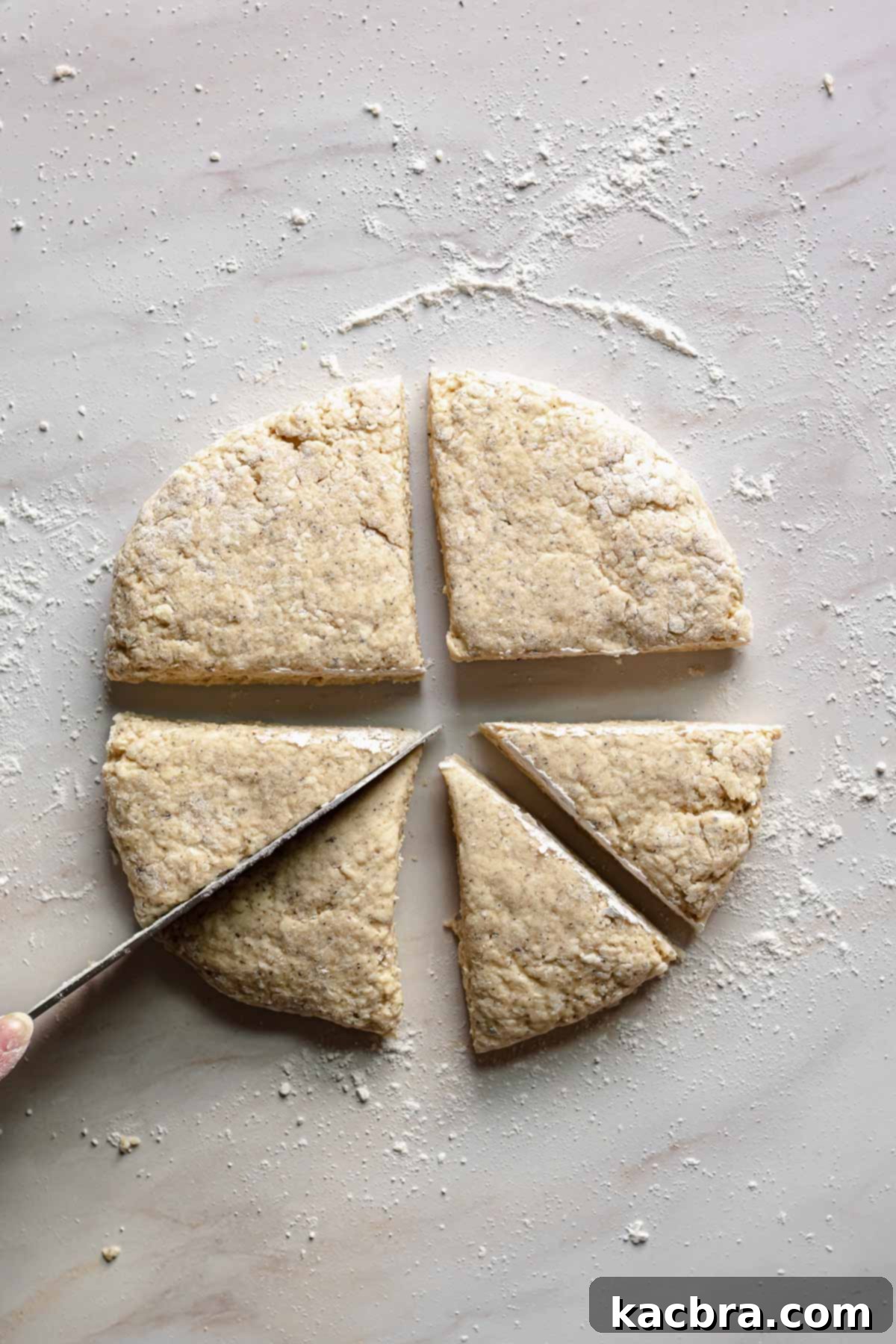 Fragrant Earl Grey Scones with Zesty Lemon Drizzle 8 Knife cutting the earl grey scones into wedges.