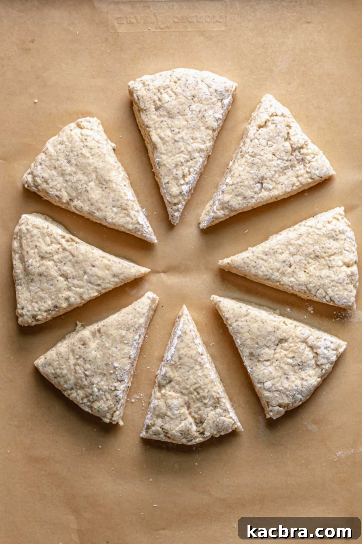 Fragrant Earl Grey Scones with Zesty Lemon Drizzle 9 Earl grey scone wedges on a tray.