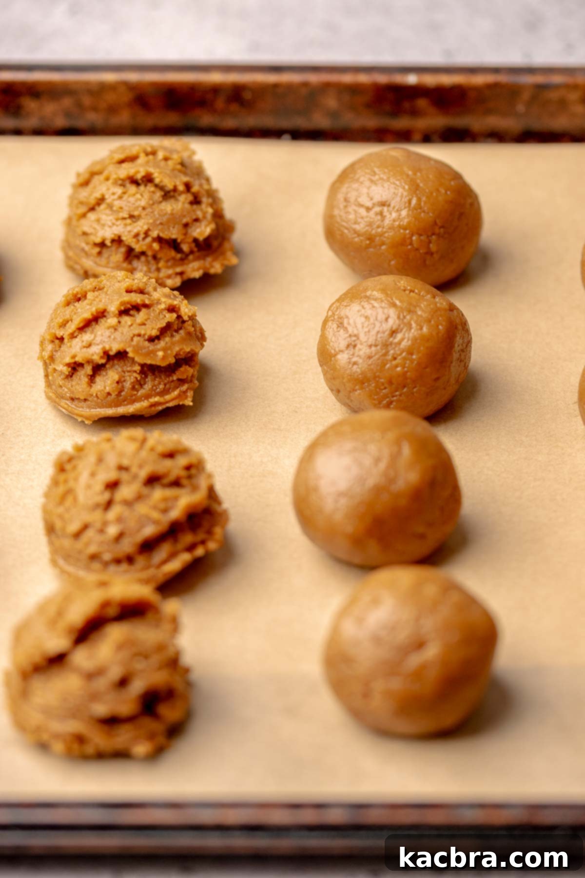 Irresistible Biscoff Cookie Truffles 8 Biscoff truffles on a baking sheet, some scooped, some rolled into smooth balls.