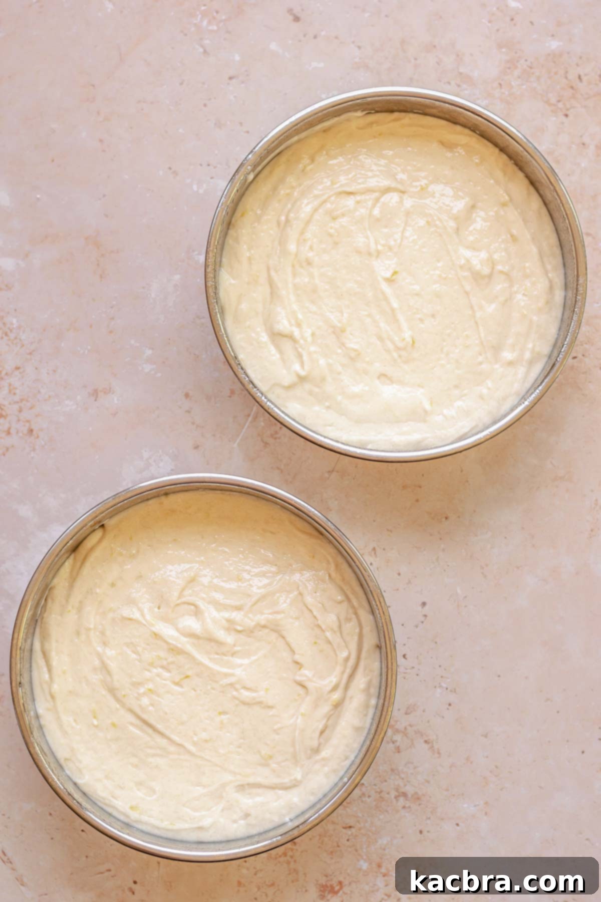 Cake batter split between two cake pans.