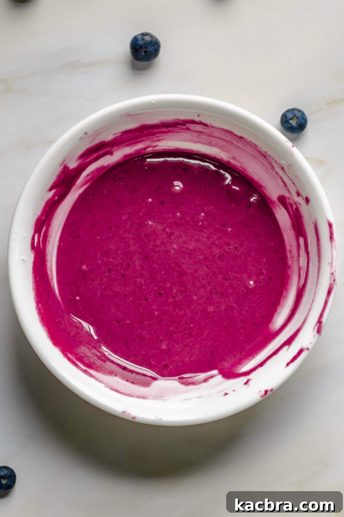 Dark colored blueberry glaze in a bowl.