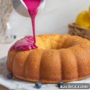 Blueberry glaze being poured onto a Bundt Cake.