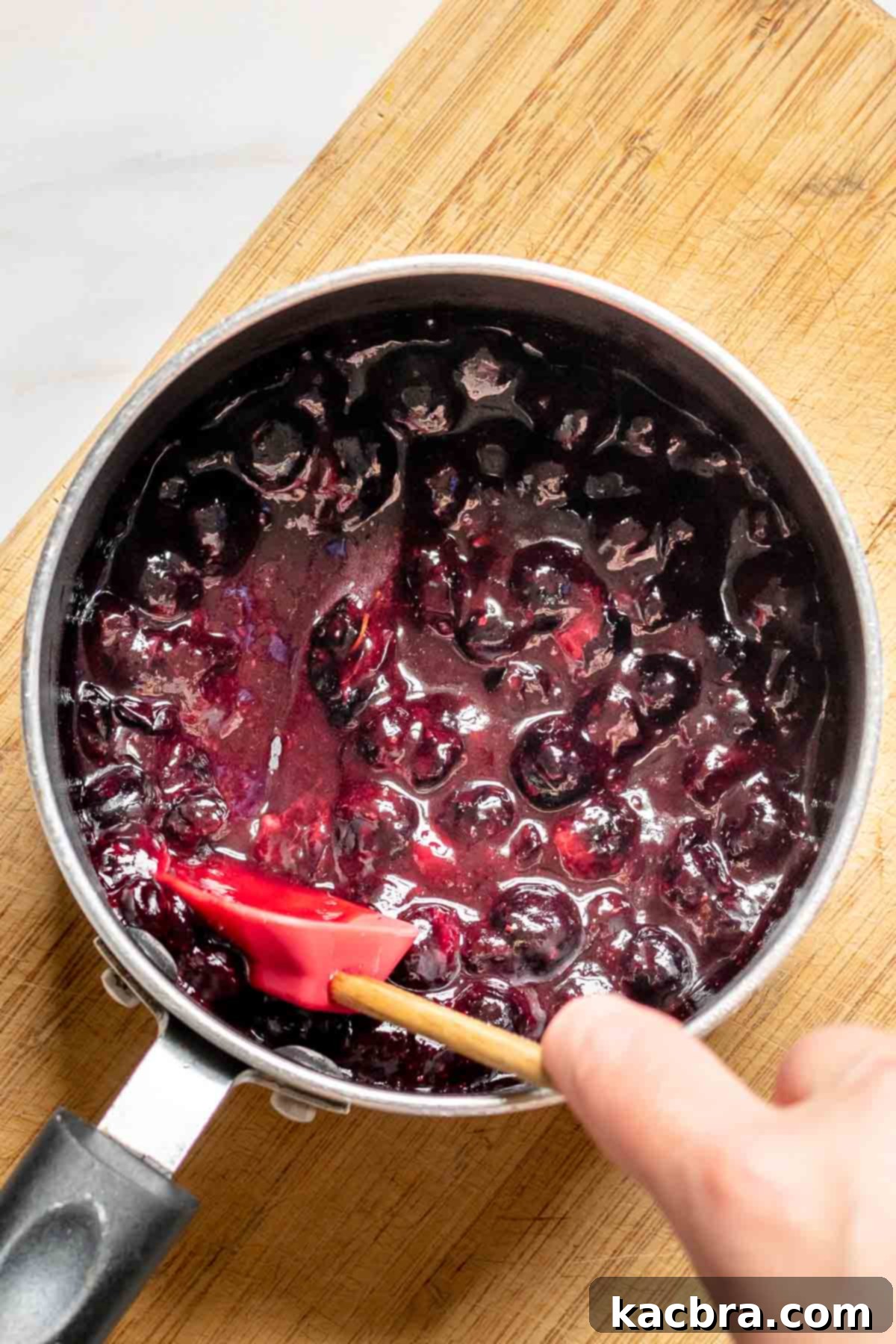 Cooked blueberries in a saucepan.
