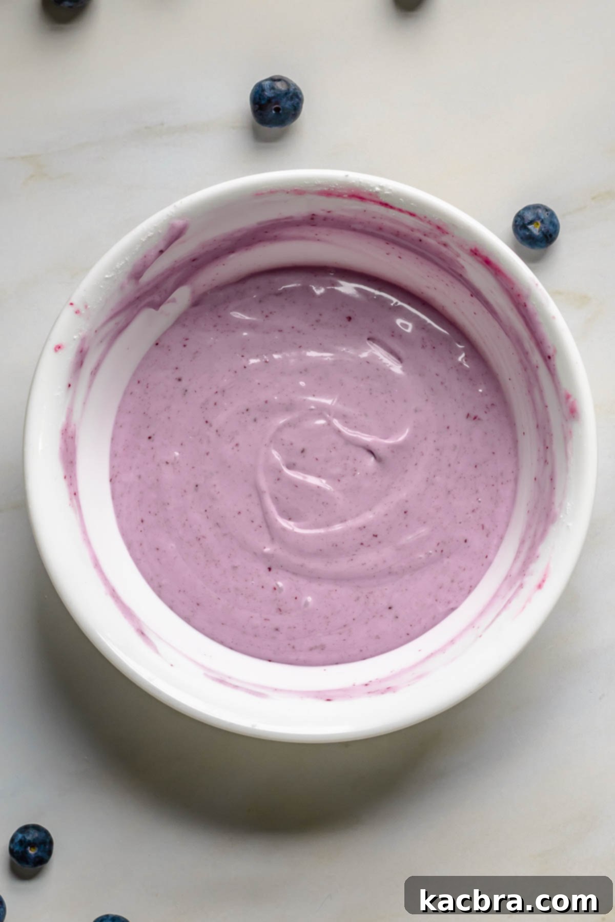 Light colored blueberry glaze in a bowl.