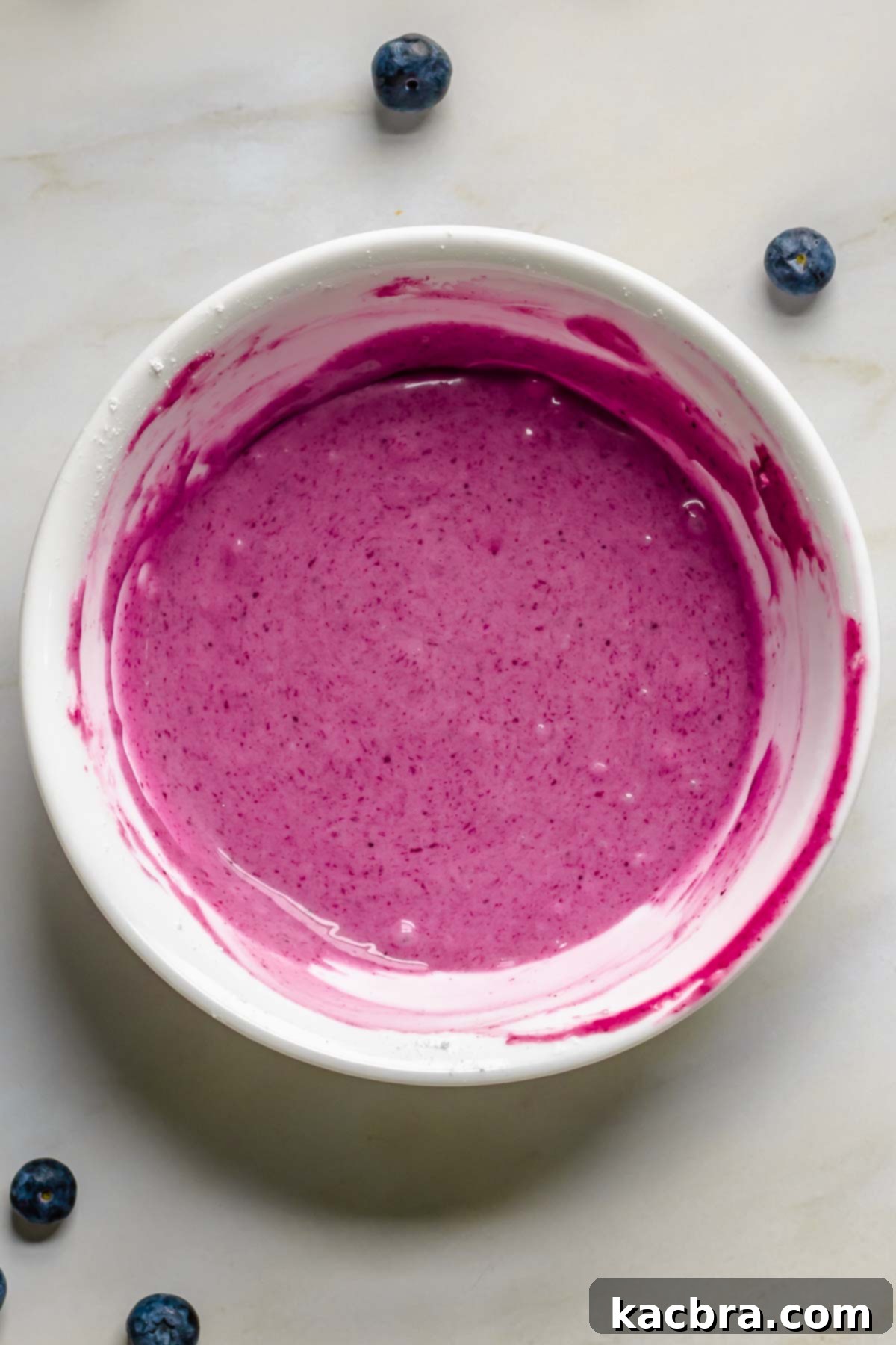 Medium colored blueberry glaze in a bowl.