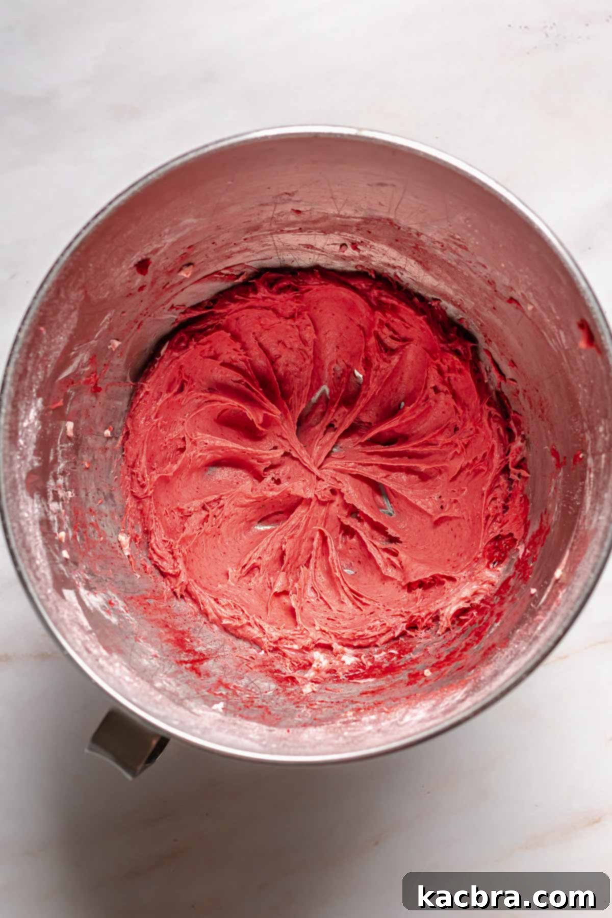 Blushing Strawberry Delights 8 A bowl filled with luscious freeze-dried strawberry frosting, showcasing its smooth texture and delicate pink color.