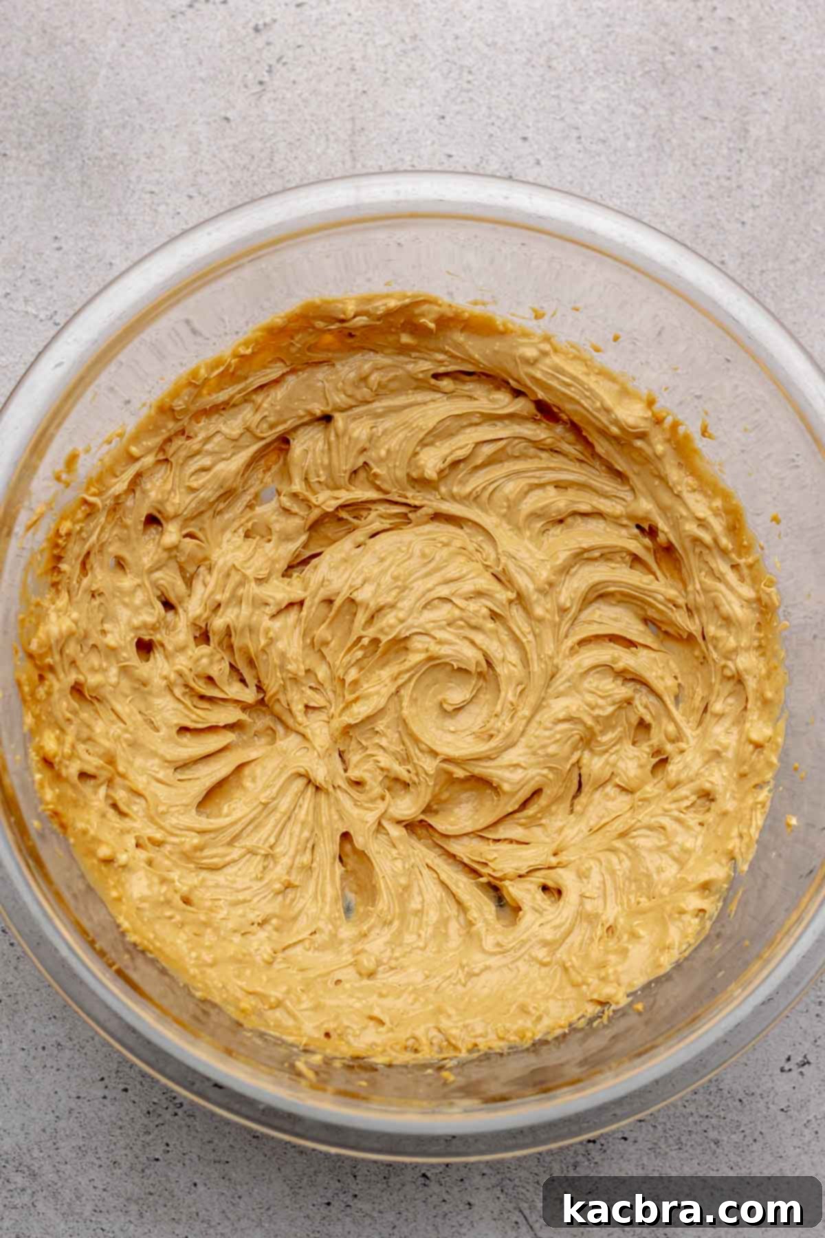 Jammy Peanut Butter Delights 5 Creamy peanut butter and softened butter being mixed together in a bowl.