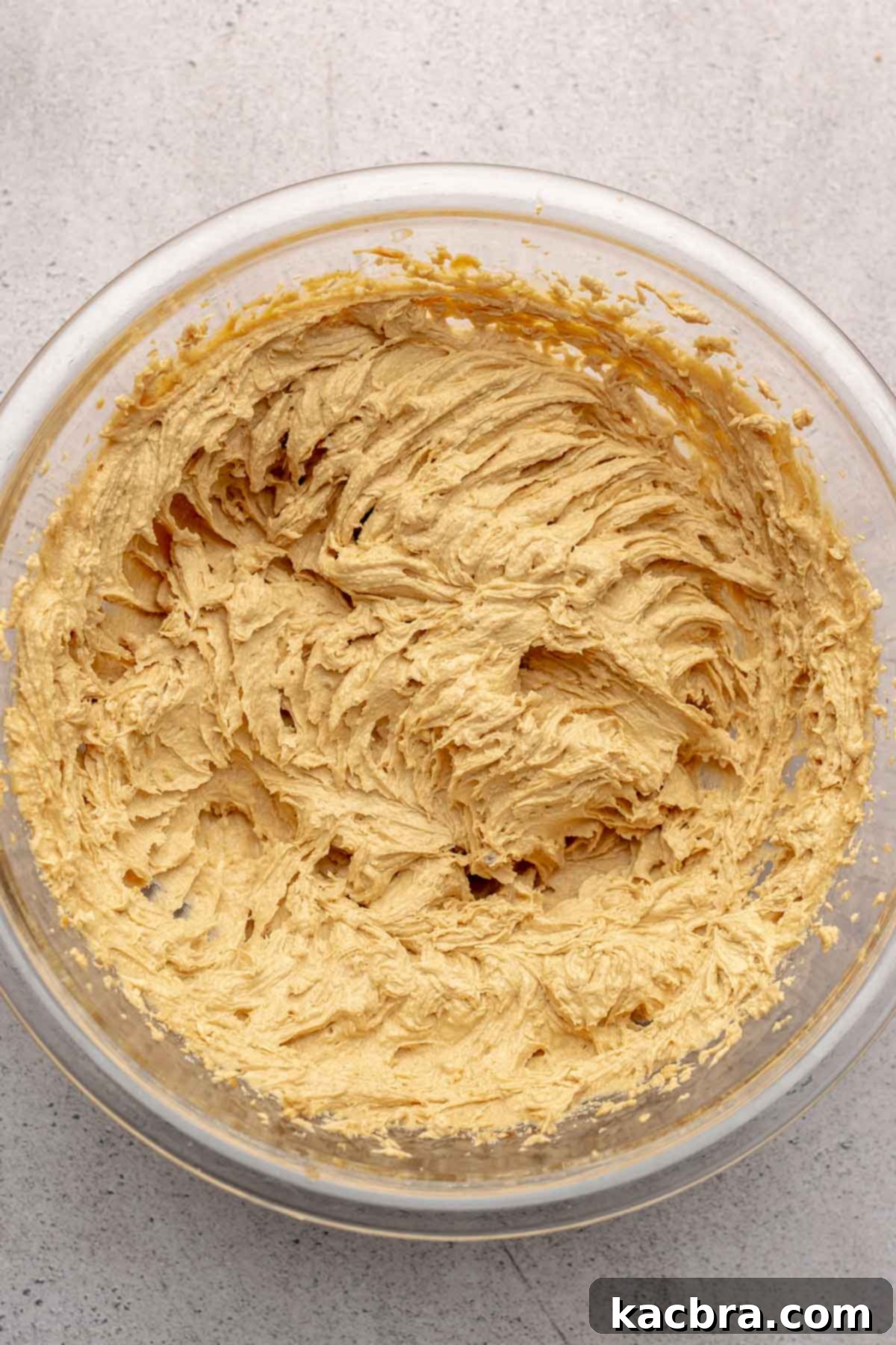 Jammy Peanut Butter Delights 6 Wet ingredients for peanut butter cookies, including egg and vanilla, mixed into the creamed butter and peanut butter.