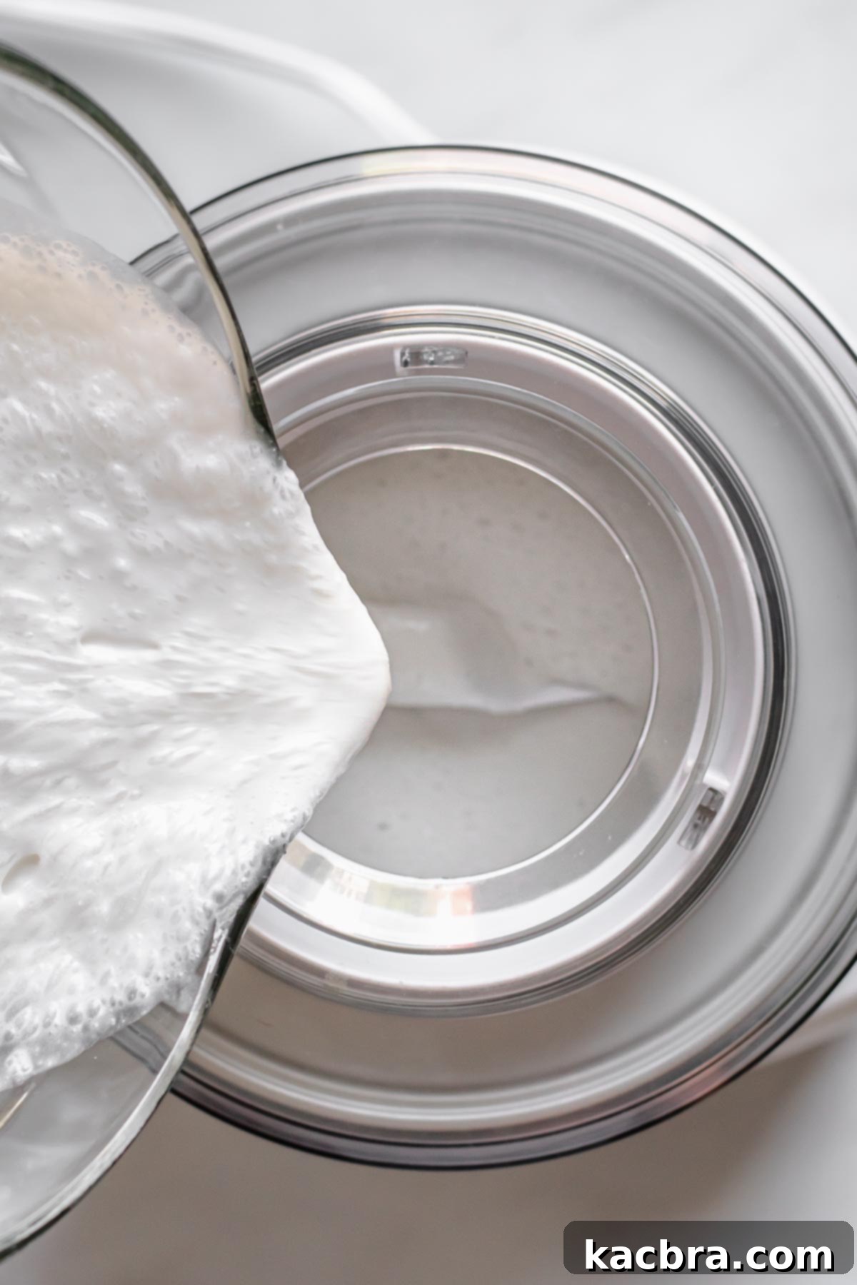 The blended coconut mixture is carefully poured into an activated ice cream machine.