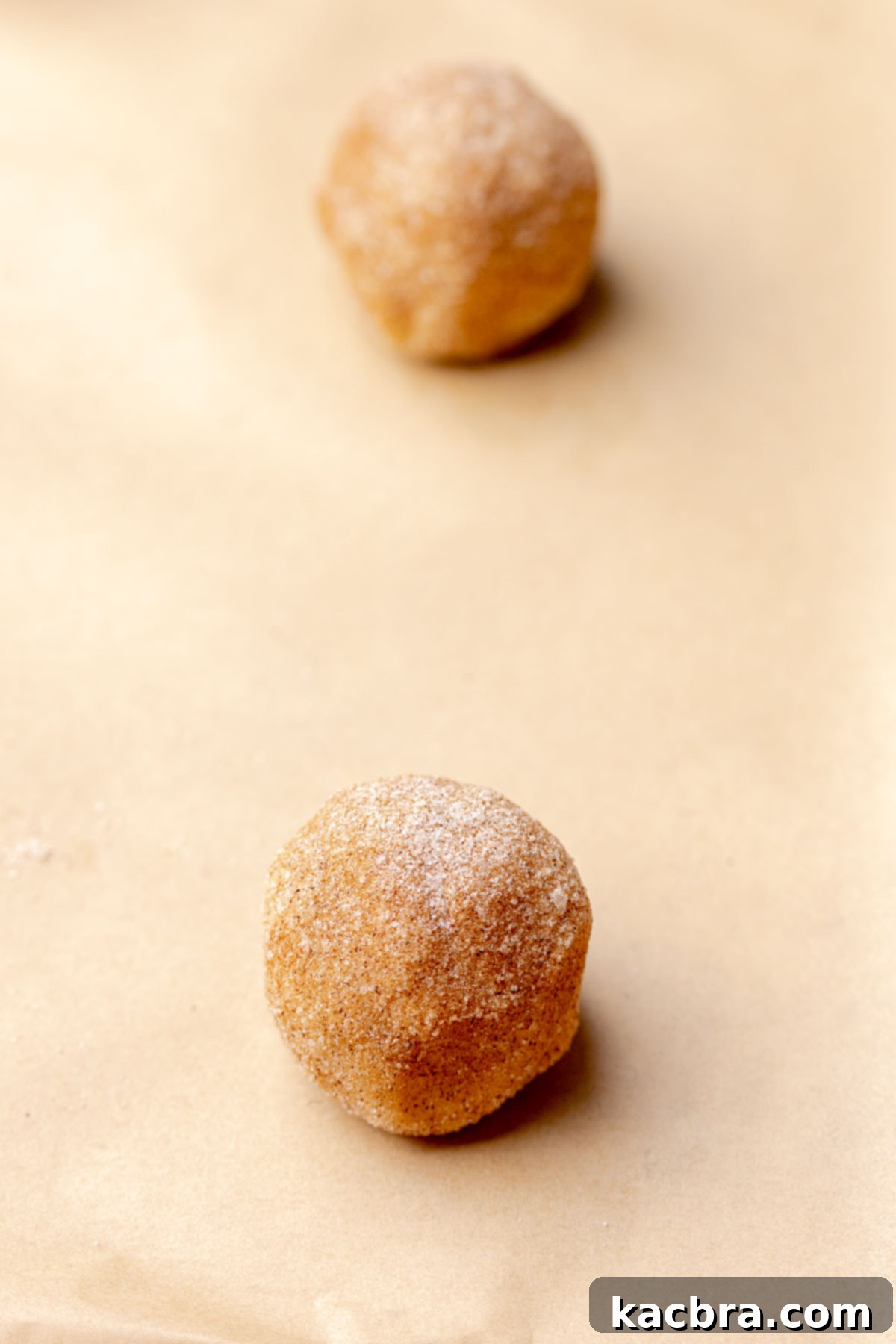 Cookie dough balls on a sheet pan.