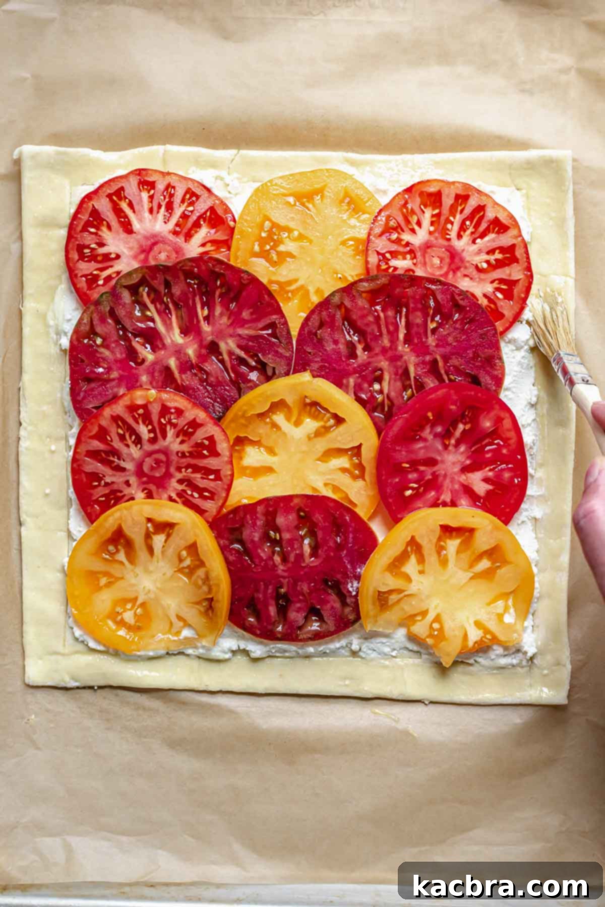 Rustic Tomato and Double Cheese Puff Pastry Tart 7 Brushing egg wash onto the tart edges before baking.