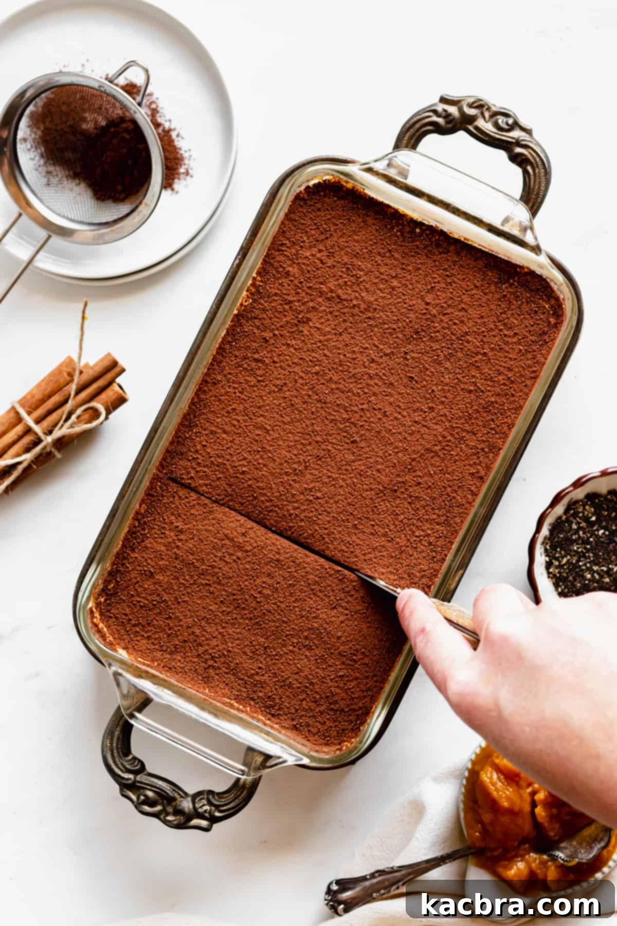 Harvest Pumpkin Chai Tiramisu 10 A knife cuts into the pumpkin chai tiramisu.