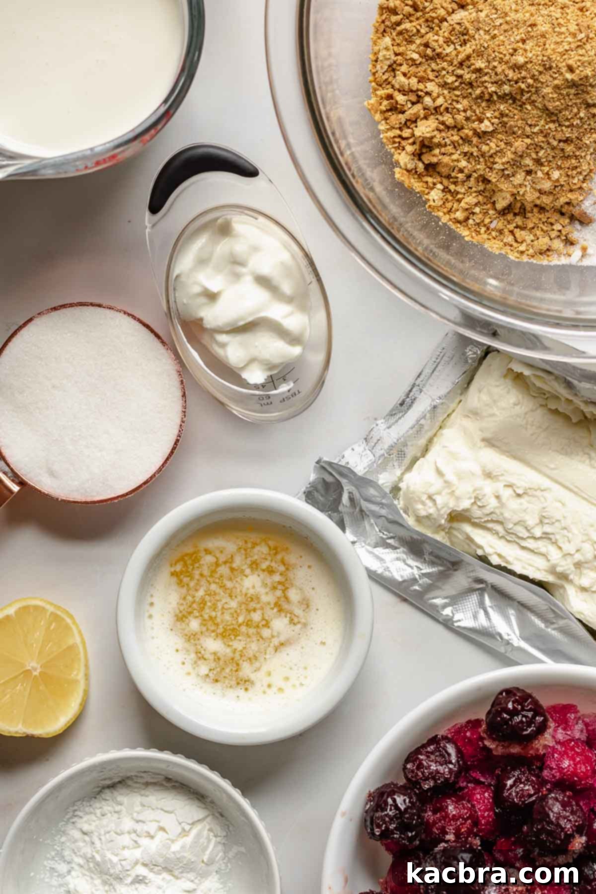Various ingredients for no bake cherry cheesecake pie laid out on a surface.