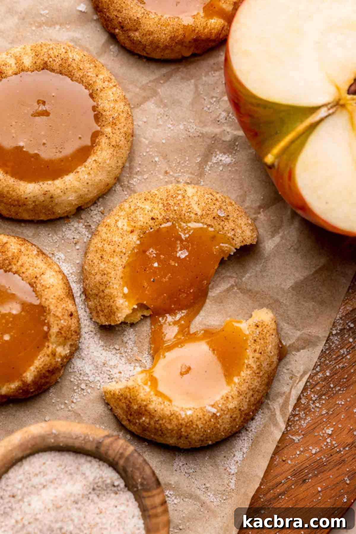 A caramel apple cider cookie broken in half so the caramel spills out.