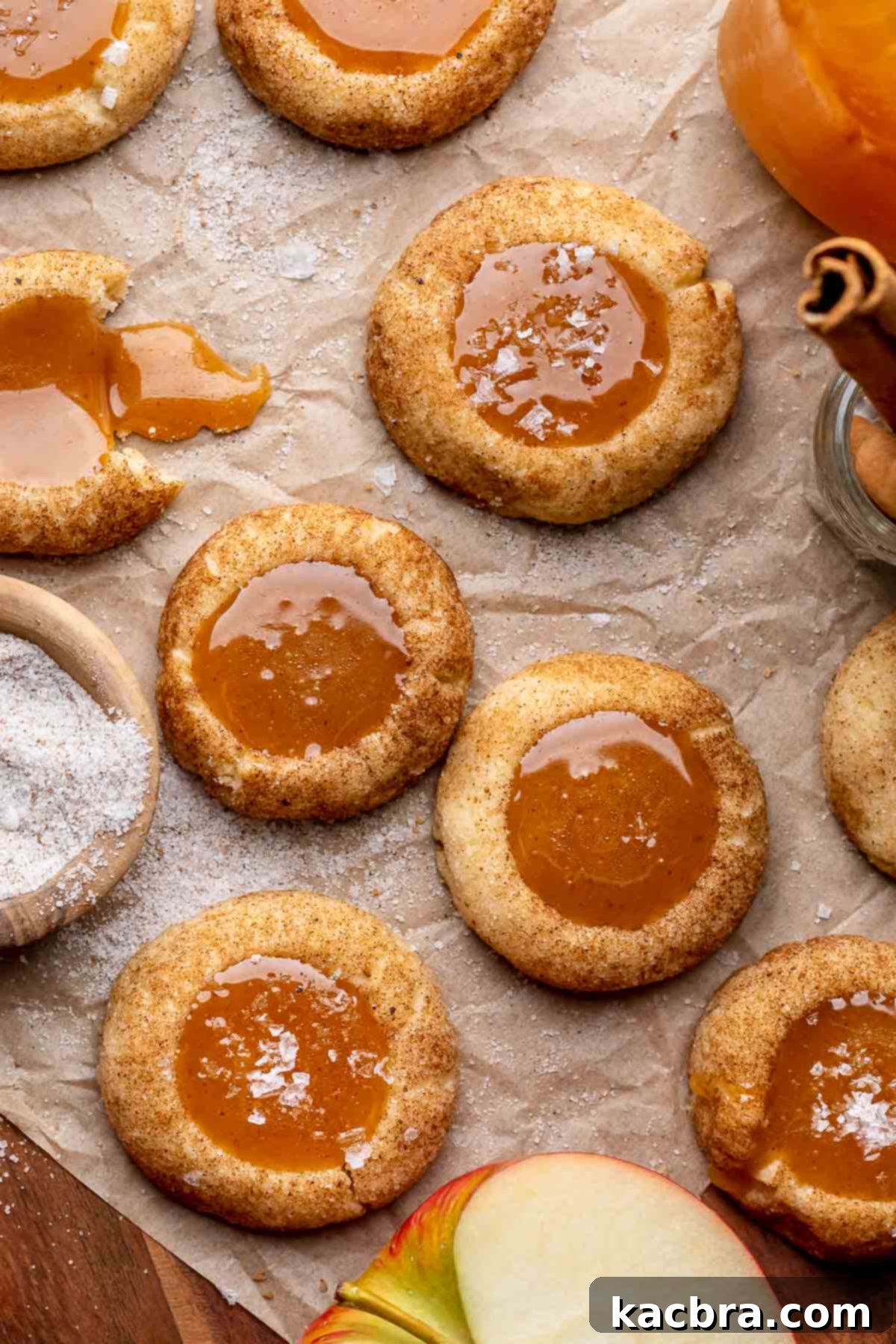 An array of caramel apple cider cookies on parchment paper.