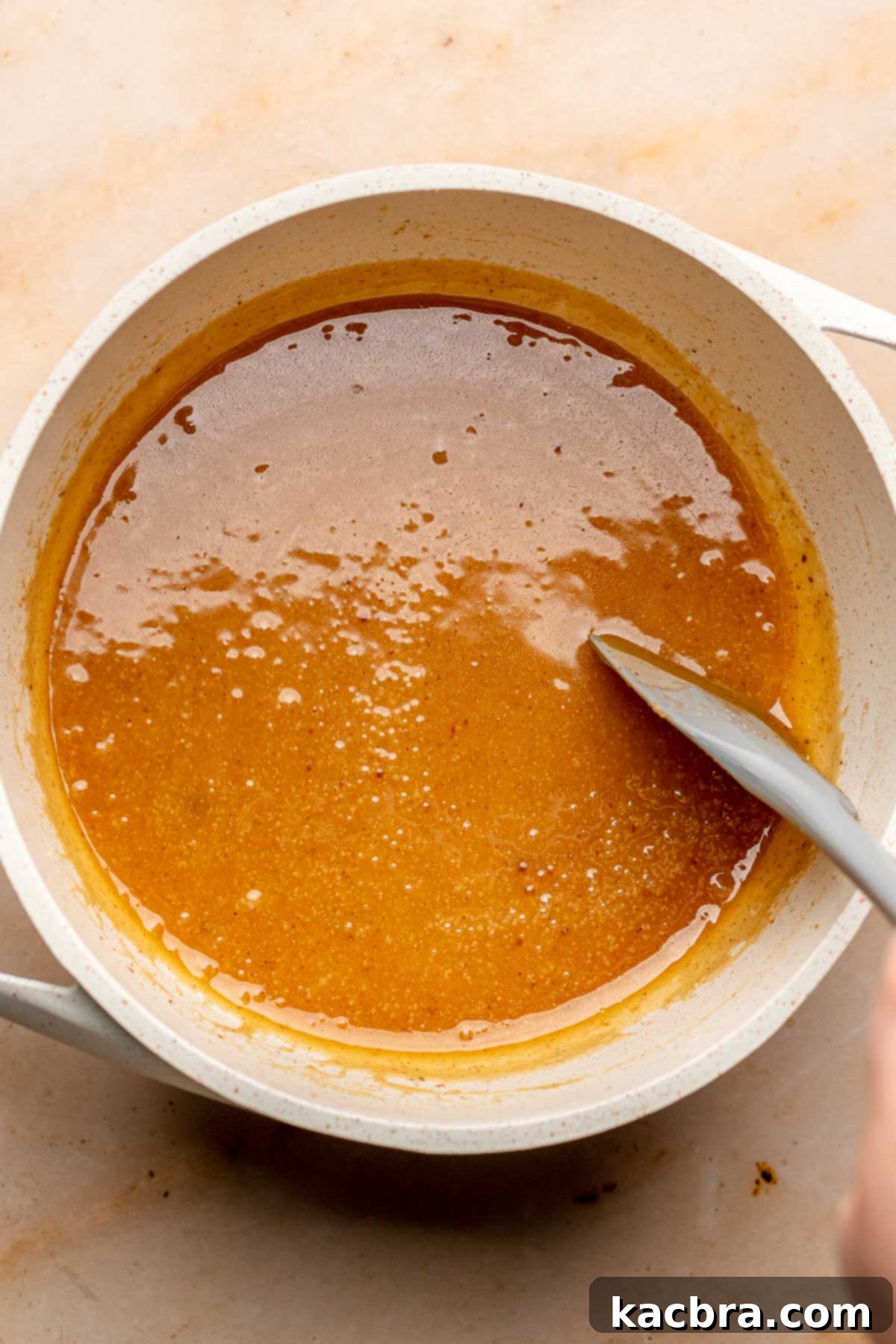 Apple cider caramel in a pot.