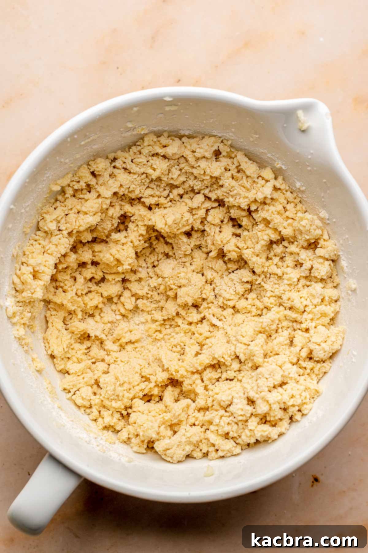 Crumbly cookie dough in a bowl.