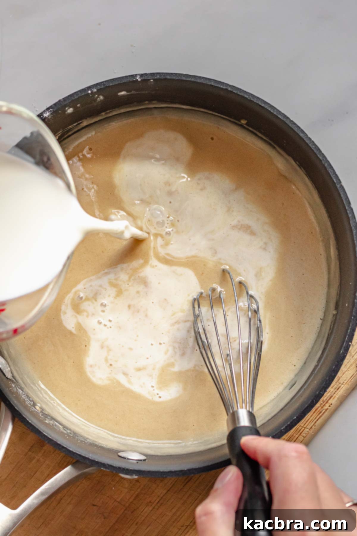 Milk being added to the beer cheese dip roux.
