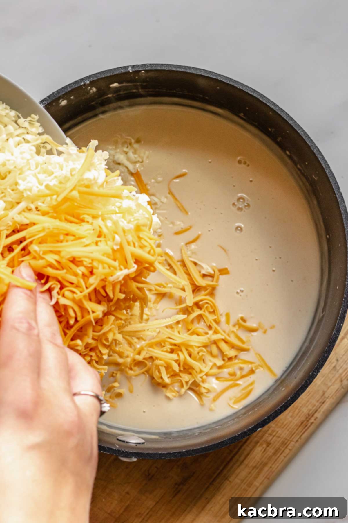 Cheese being added to the beer dip.