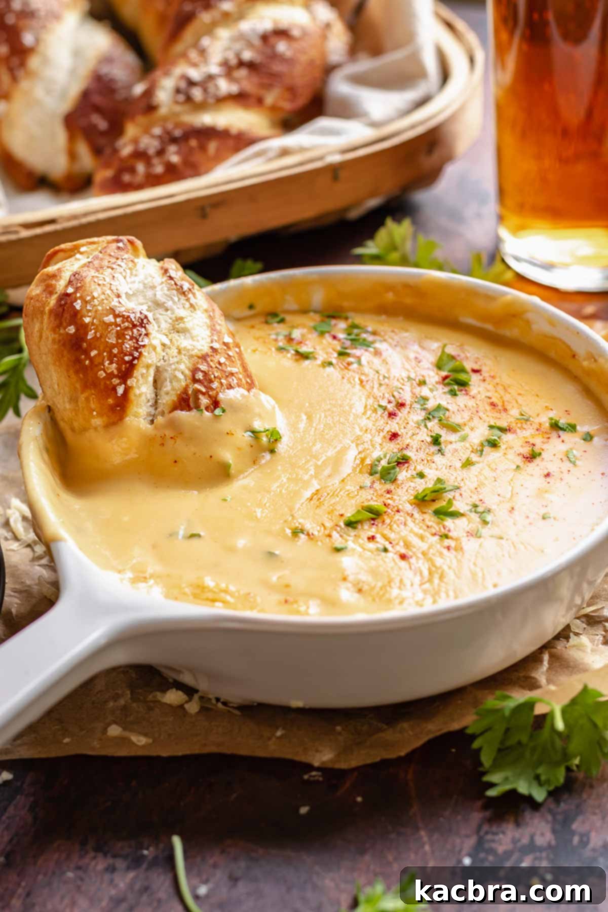 Soft pretzel in a bowl of beer cheese.