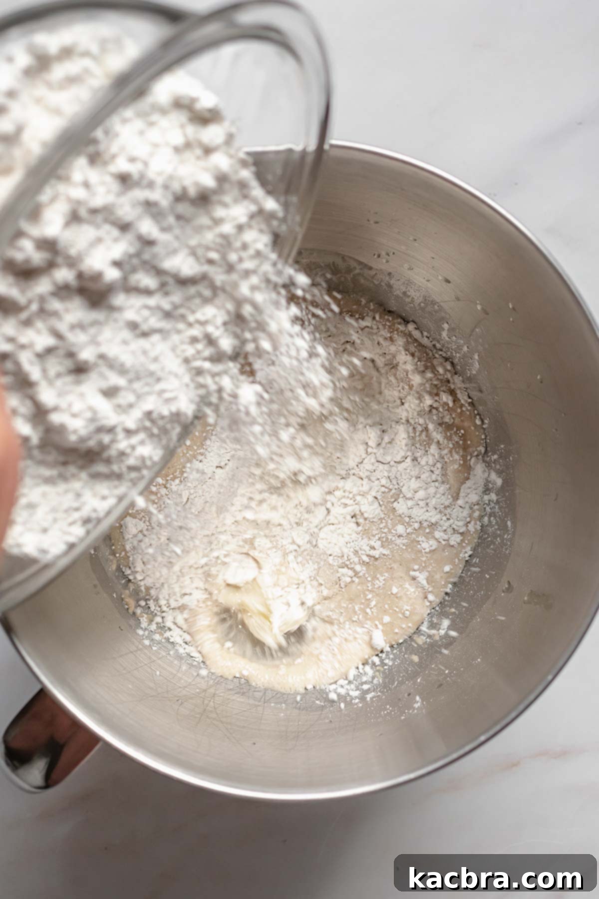 Flour getting added to pretzel dough.