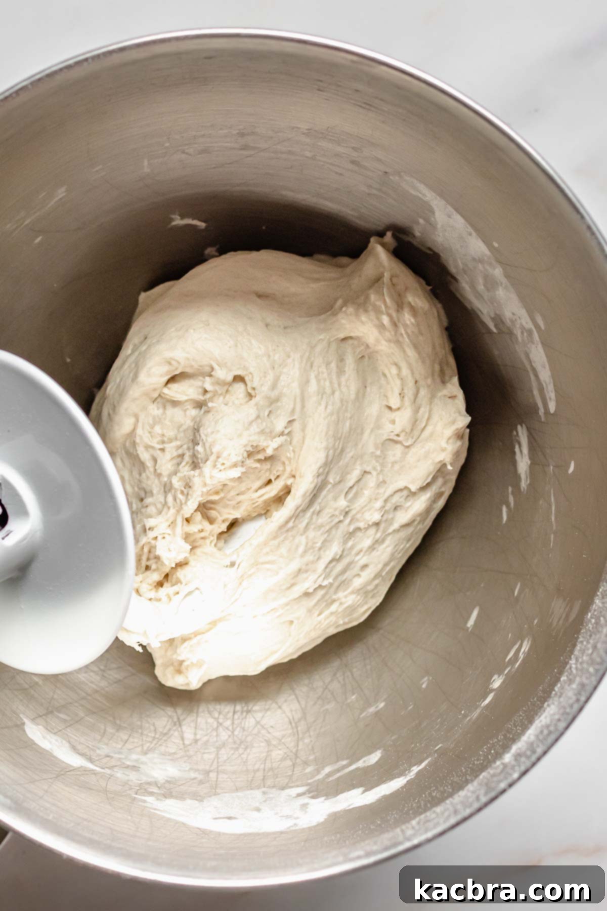 Finished pretzel dough in a stand mixer bowl.