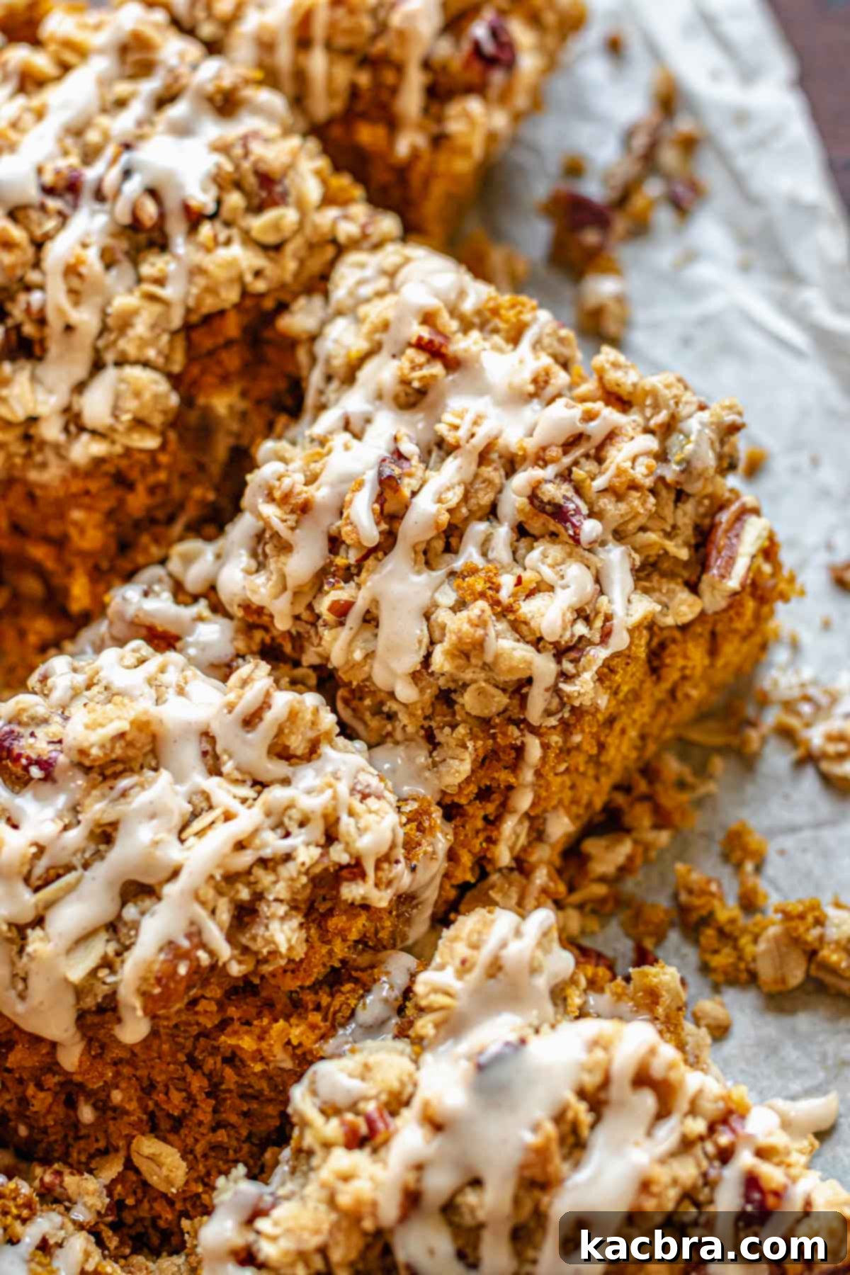 Slices of pumpkin coffee cake on a table, showcasing its moist texture and streusel topping.