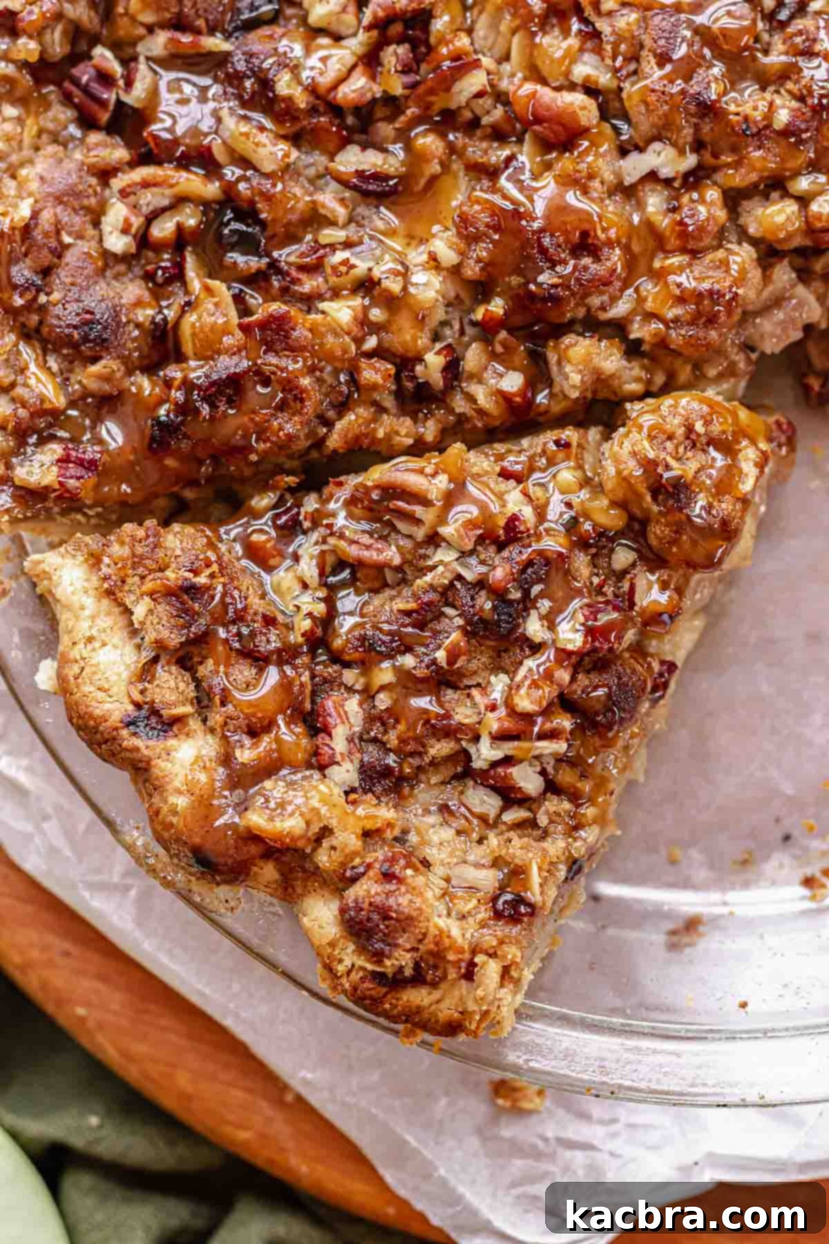 Apple pie with crumb top sliced in a pie dish.