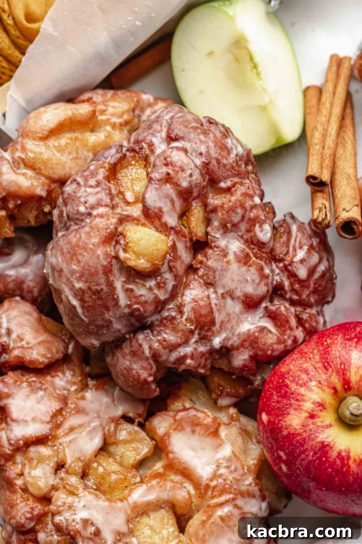 A beautifully arranged basket of apple fritter donuts, adorned with fresh apples and cinnamon sticks, evoking a cozy autumn vibe.