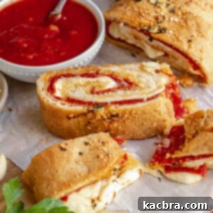 Pepperoni bread sliced on a board with one piece split with melty cheese.