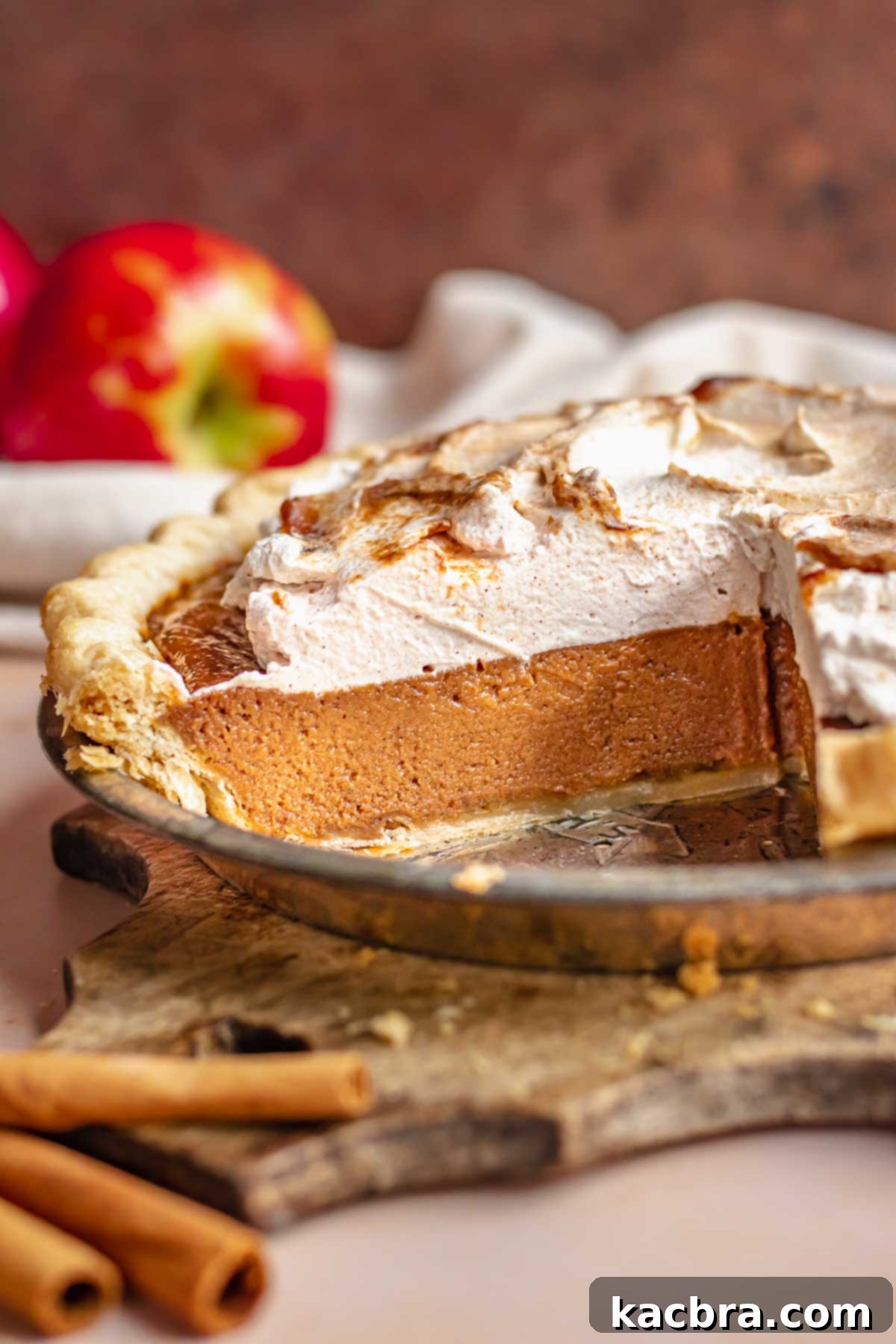 A freshly baked apple butter pie with several slices already removed, showcasing its delicious appeal and readiness to be enjoyed.