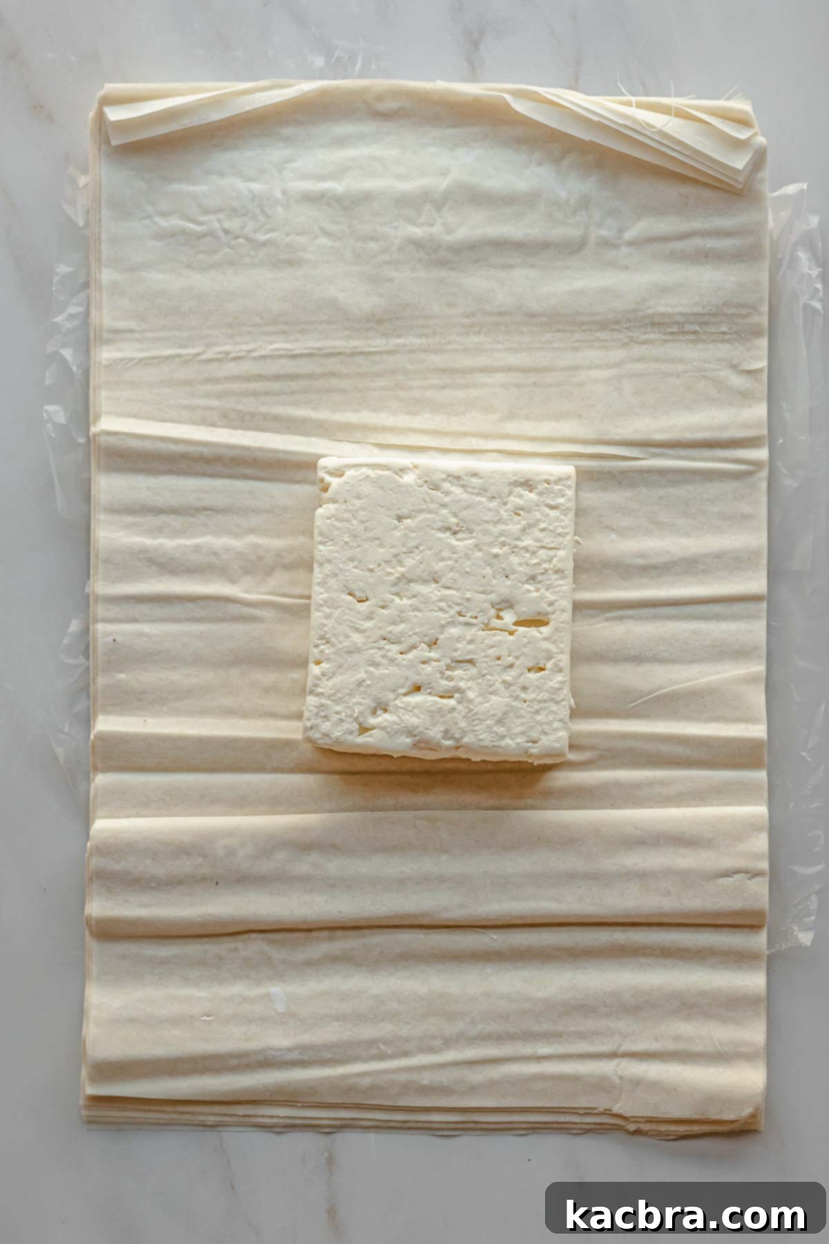 A block of feta cheese on phyllo pastry.