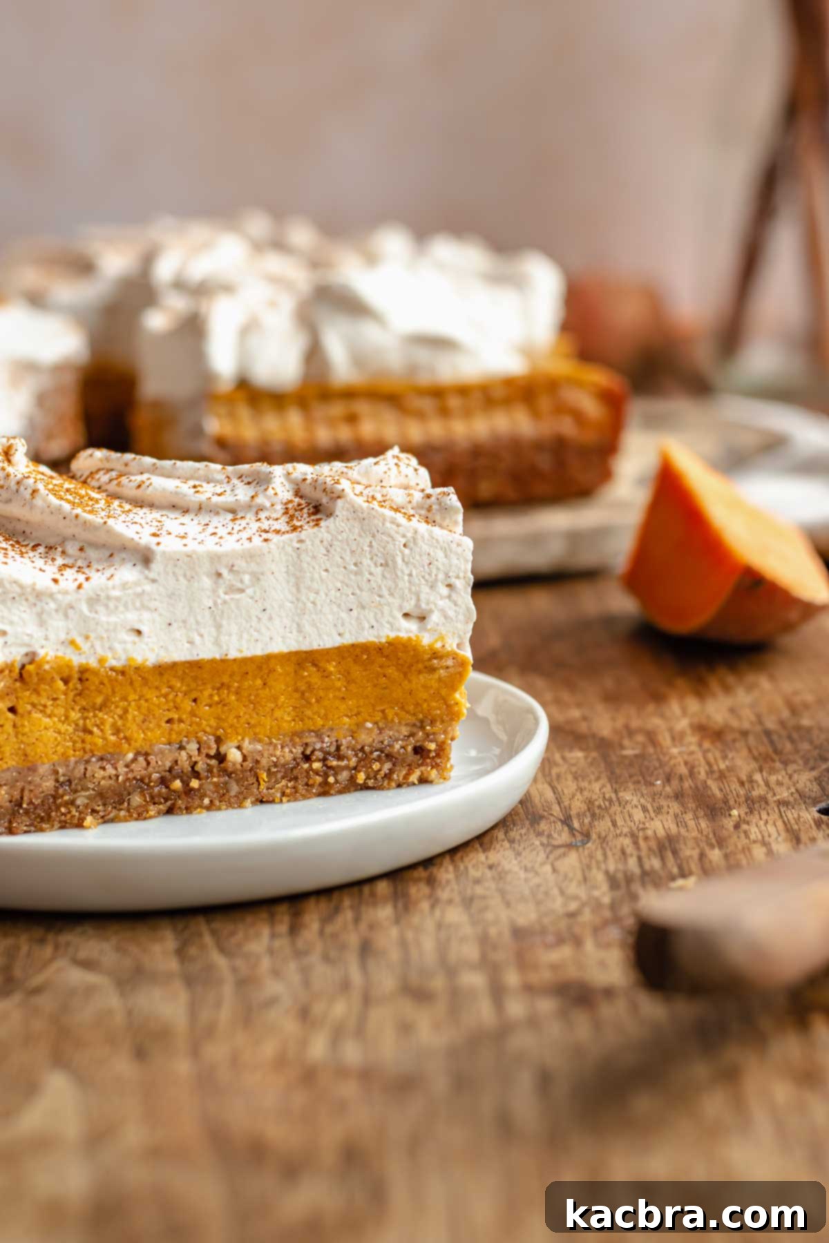 A single sweet potato pie bar elegantly presented on a white plate, showcasing its layers.