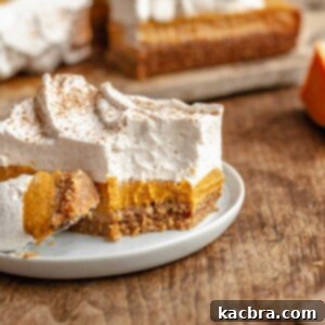 Sweet potato pie bar on a plate with a bite removed, illustrating its delicious appeal.