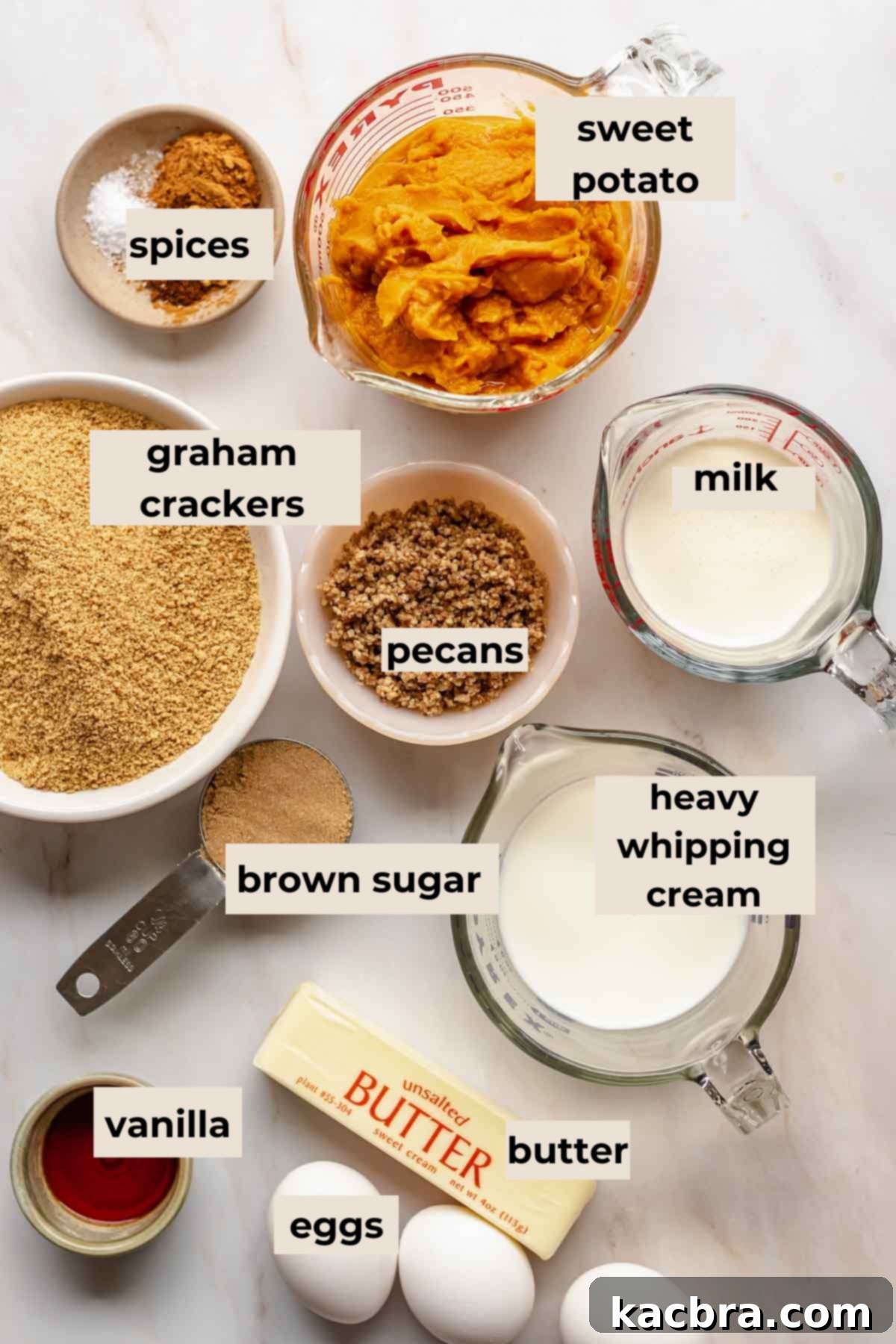 A rustic display of fresh sweet potatoes, spices, graham crackers, and other ingredients ready for making sweet potato bars.