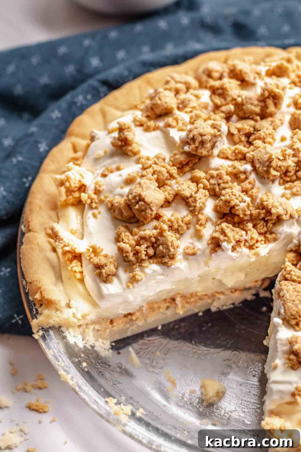 Amish peanut butter pie in a pie dish with a slice removed, revealing the creamy layers within.