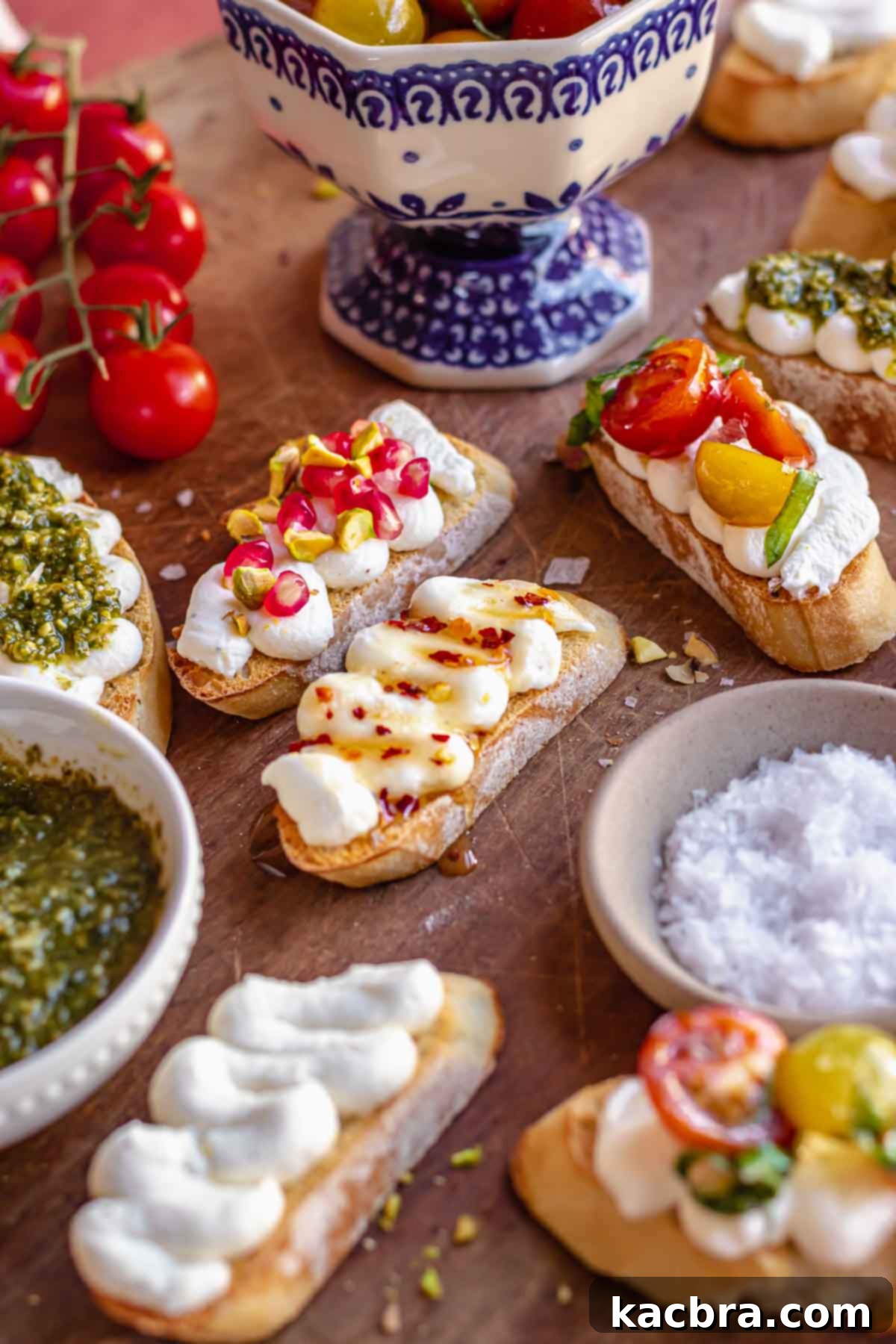 Fluffy Ricotta Crostini 10 Ricotta crostinis arranged on a board with toppings surrounding them.