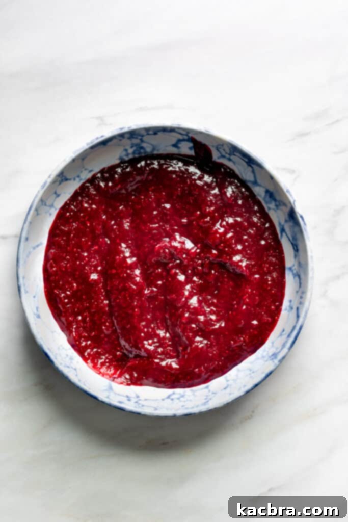 Image showing cranberry filling being pureed with an immersion blender.