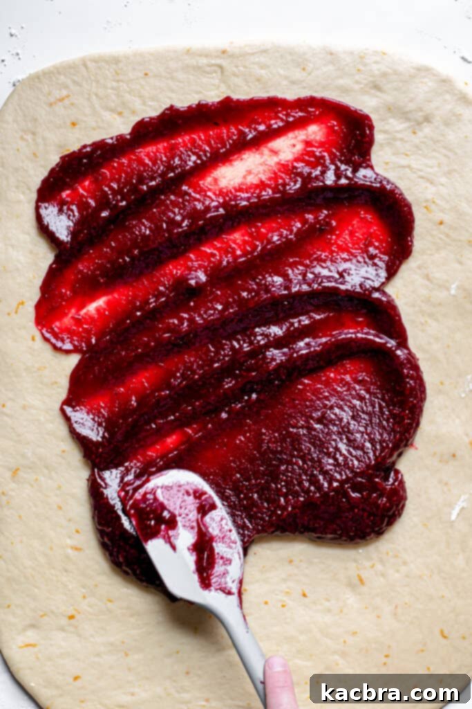 Image showing cranberry filling spread on the dough.