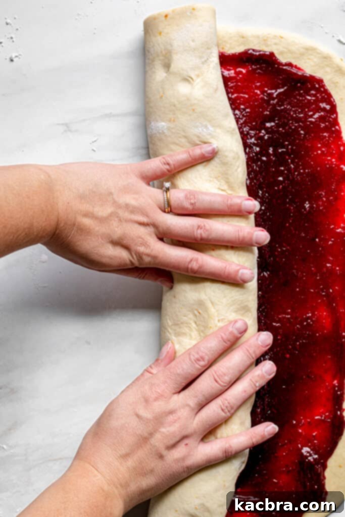 Image showing dough being rolled with filling.