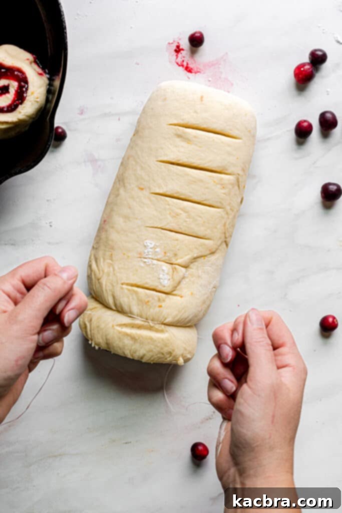 Image showing dental floss cutting dough into rolls.