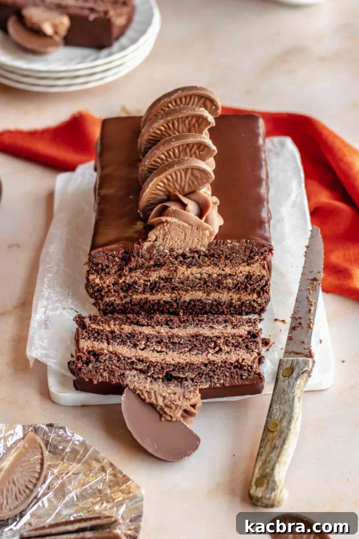 Decadent Chocolate Orange Bliss 2 A visually stunning Terry's Chocolate Orange cake, beautifully sliced on a serving board, revealing moist dark chocolate layers and vibrant orange ganache filling, ready to be enjoyed.