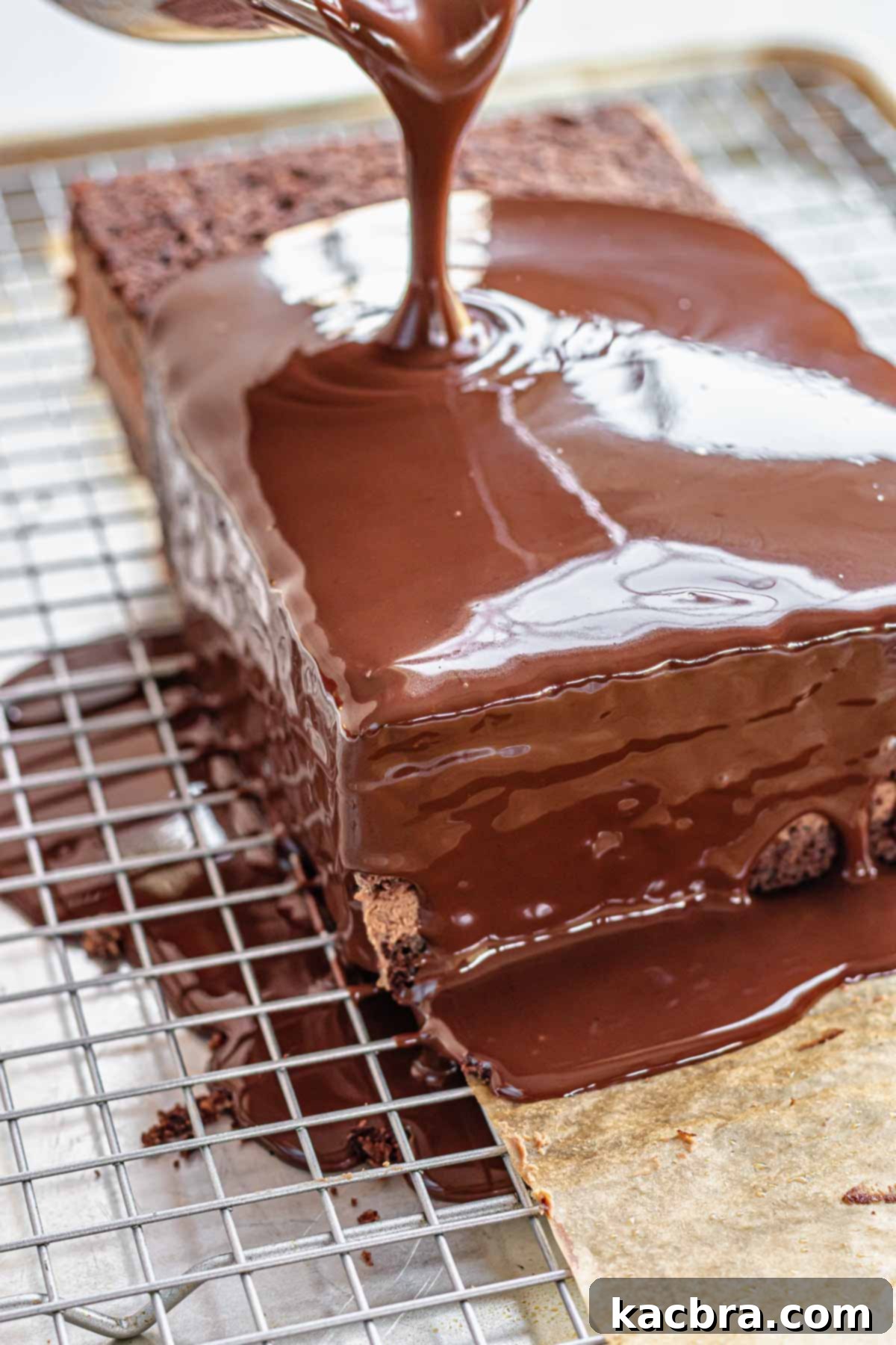 Decadent Chocolate Orange Bliss 16 Chocolate ganache pours chocolate ganache over the assembled cake, creating a smooth, glossy coating.