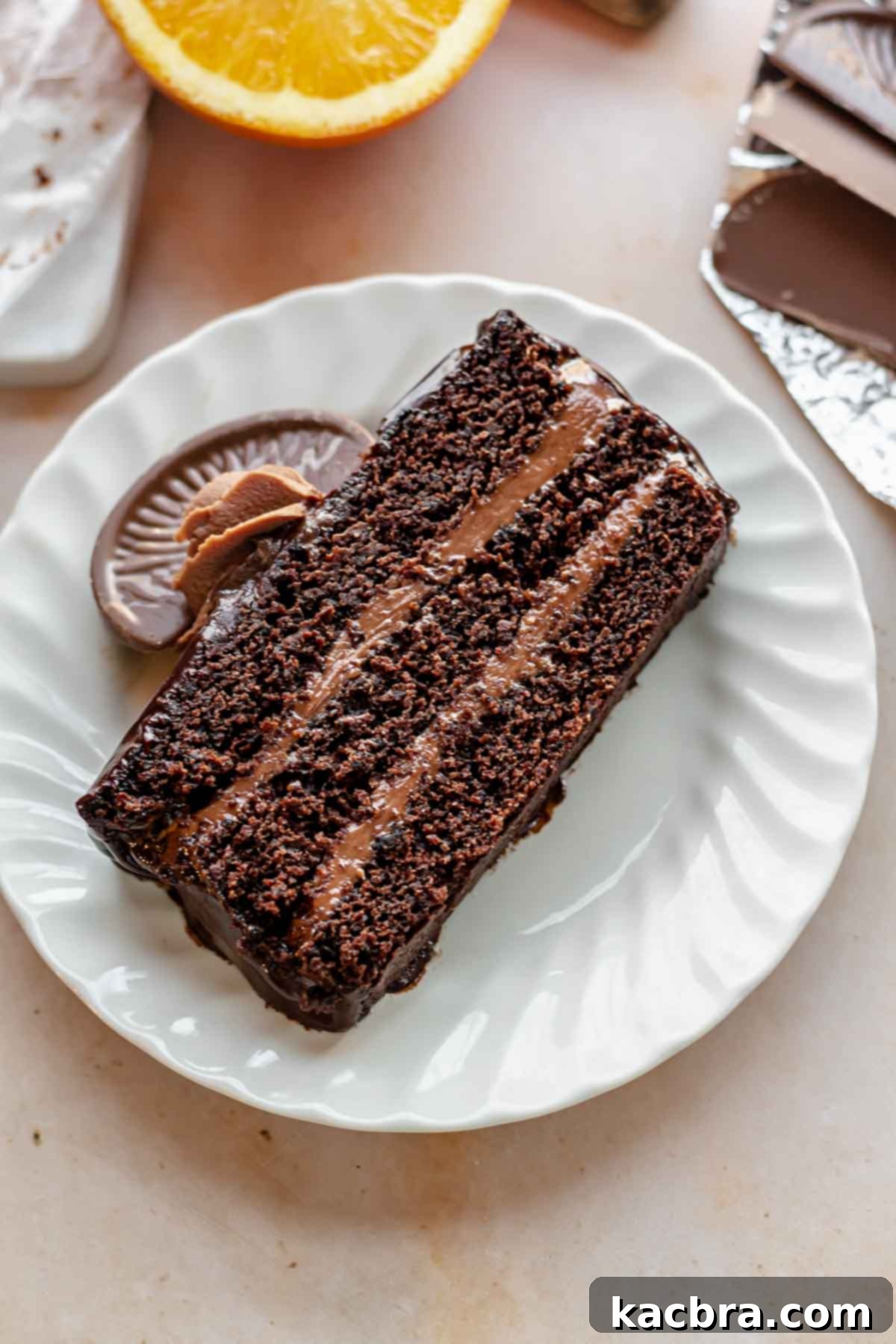 Decadent Chocolate Orange Bliss 3 A perfectly portioned slice of Terry's Chocolate Orange cake resting on an elegant white plate, showcasing its distinct layers and inviting texture.