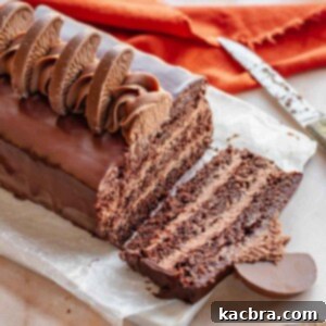 Decadent Chocolate Orange Bliss 18 A festive Terry's Chocolate Orange cake with a perfect slice removed, displaying its luscious layers of chocolate cake and orange ganache, ready for serving.