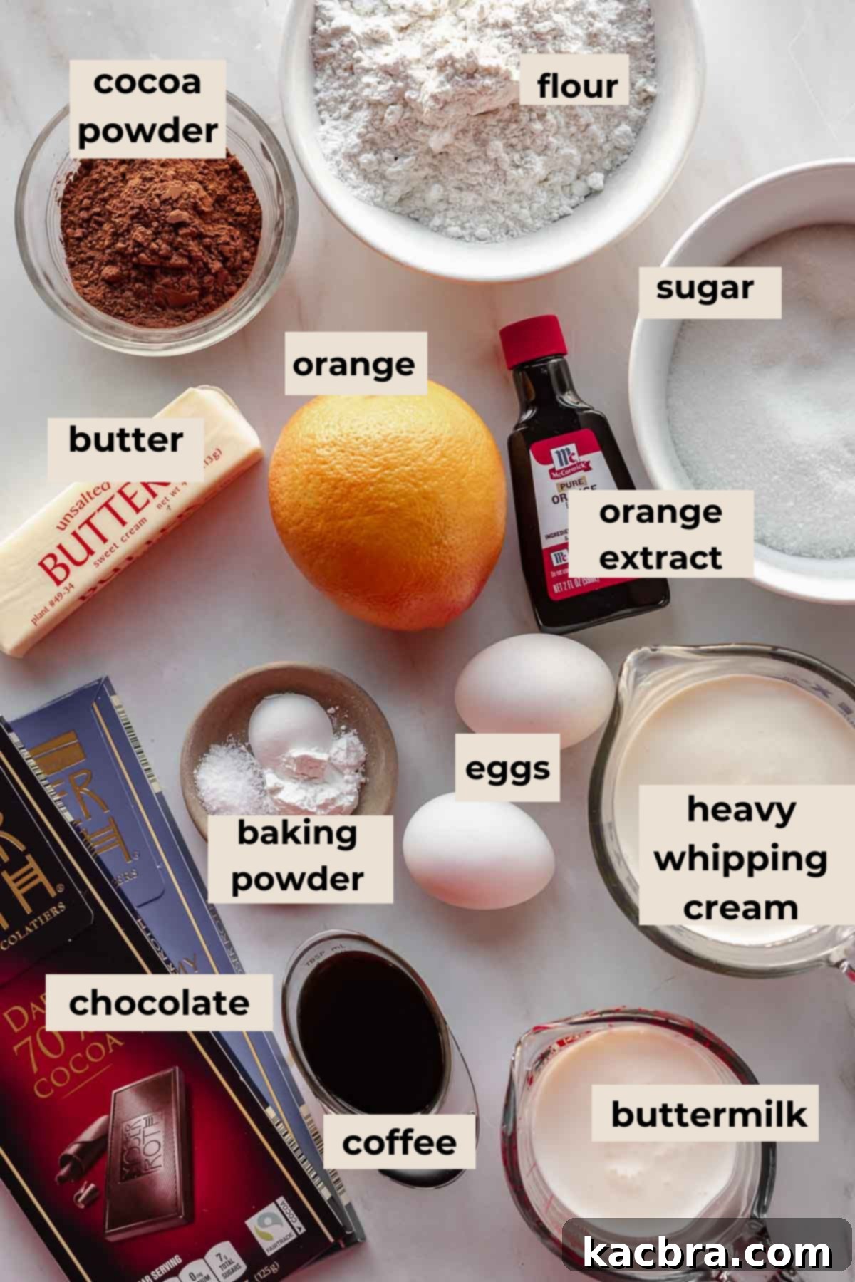 Decadent Chocolate Orange Bliss 4 An array of fresh, high-quality ingredients neatly arranged on a counter, including cocoa powder, fresh oranges, various chocolates, heavy cream, and more, all ready for baking the Terry's Chocolate Orange cake.