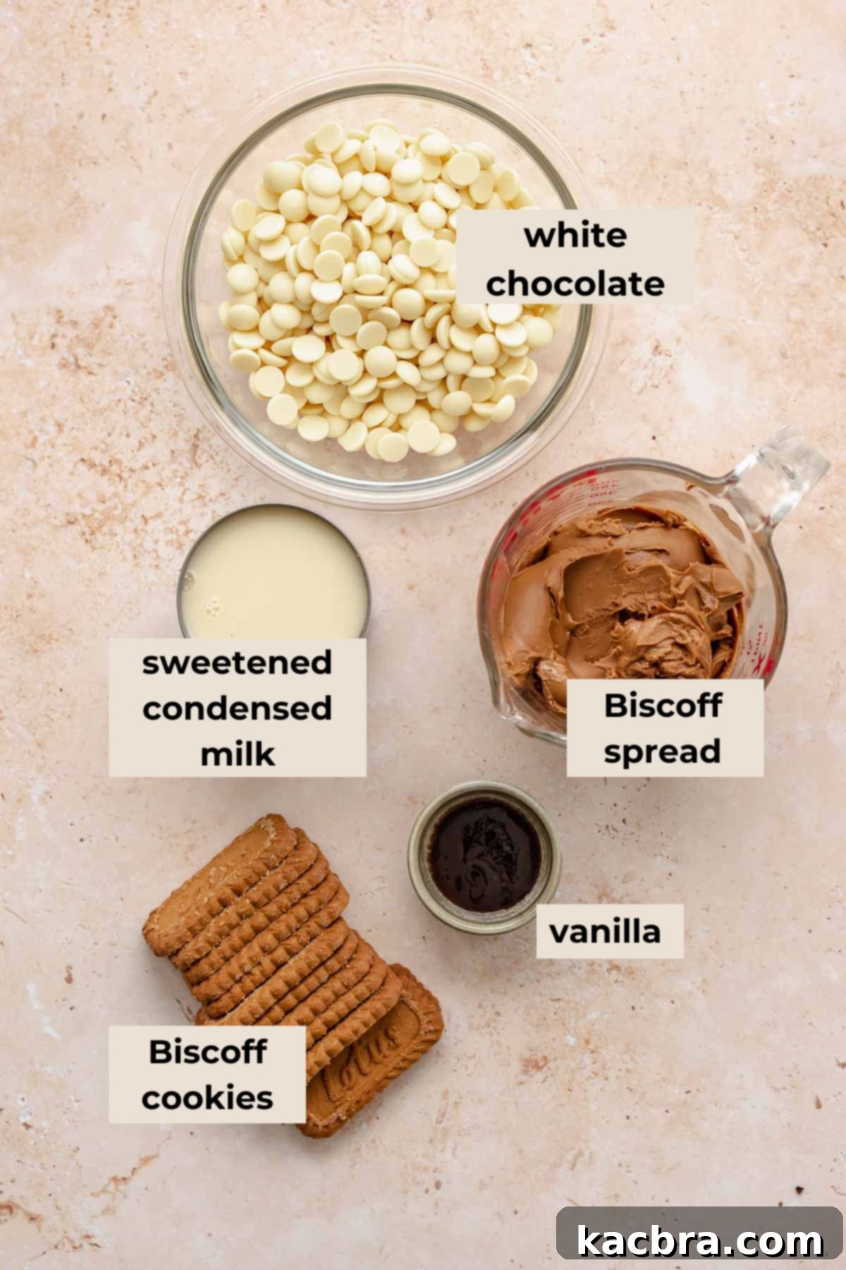 All ingredients for Biscoff fudge laid out: white chocolate chips, sweetened condensed milk, Biscoff spread, and Biscoff cookies.