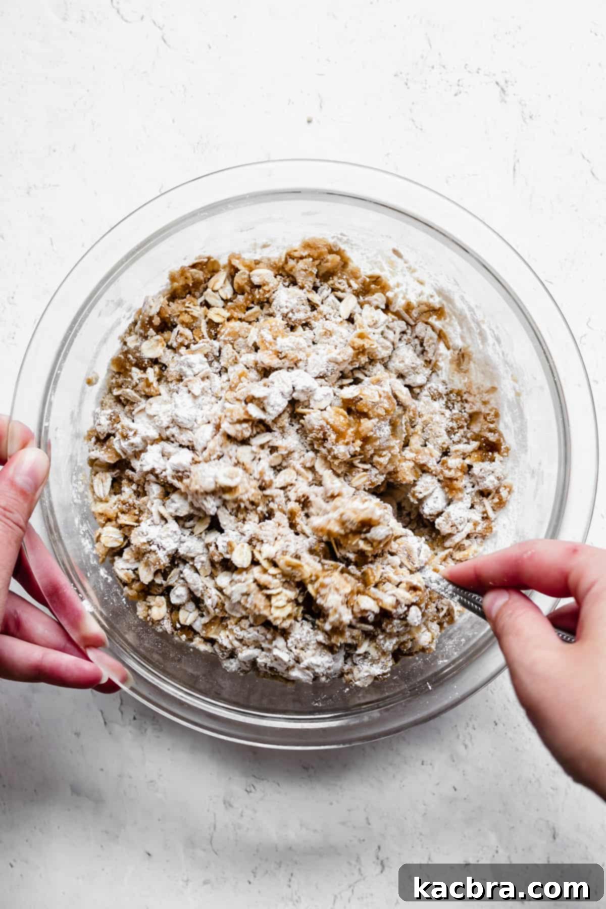 a fork stirs together the crumble topping