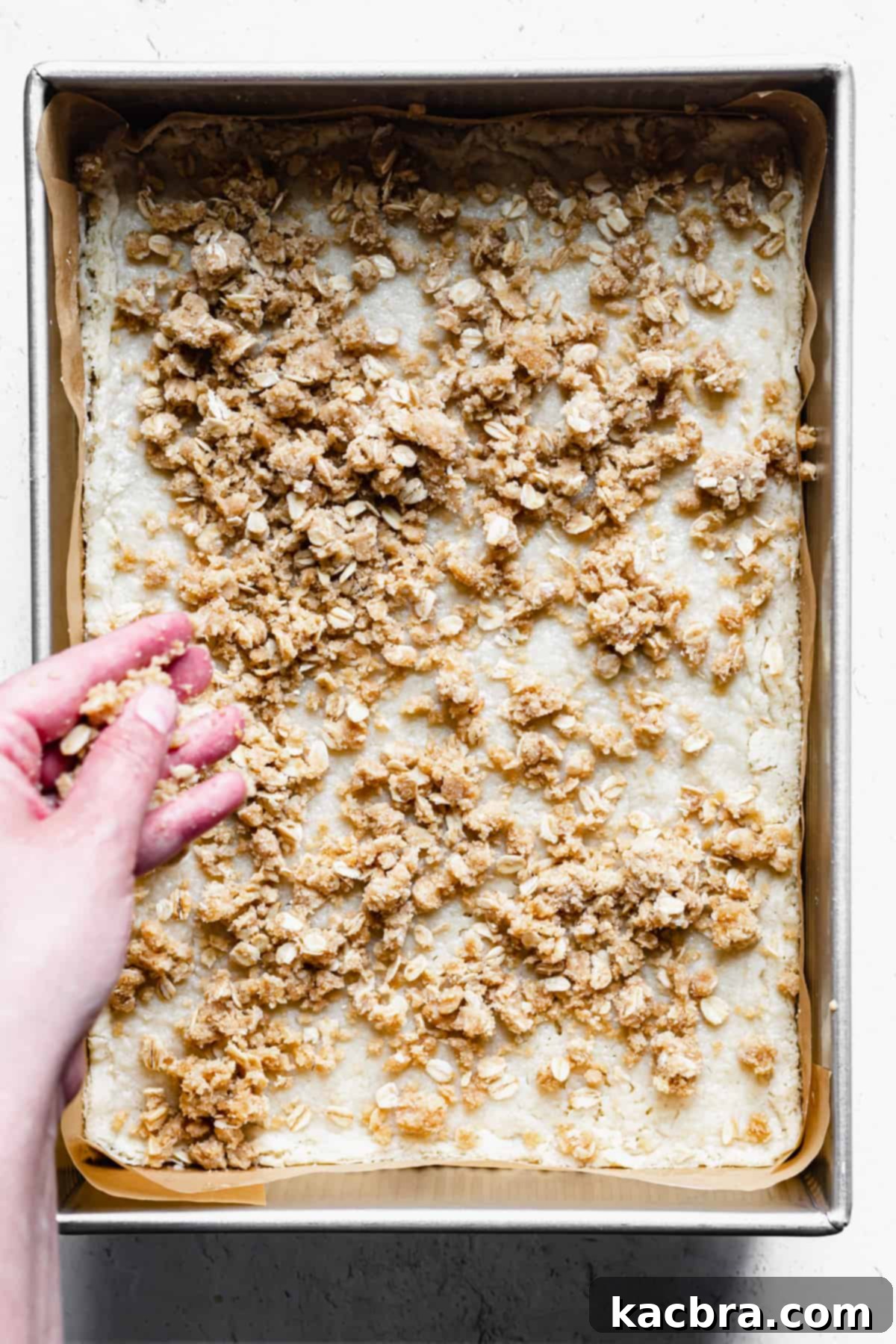 crumble topping gets scattered on the par-baked shortbread base